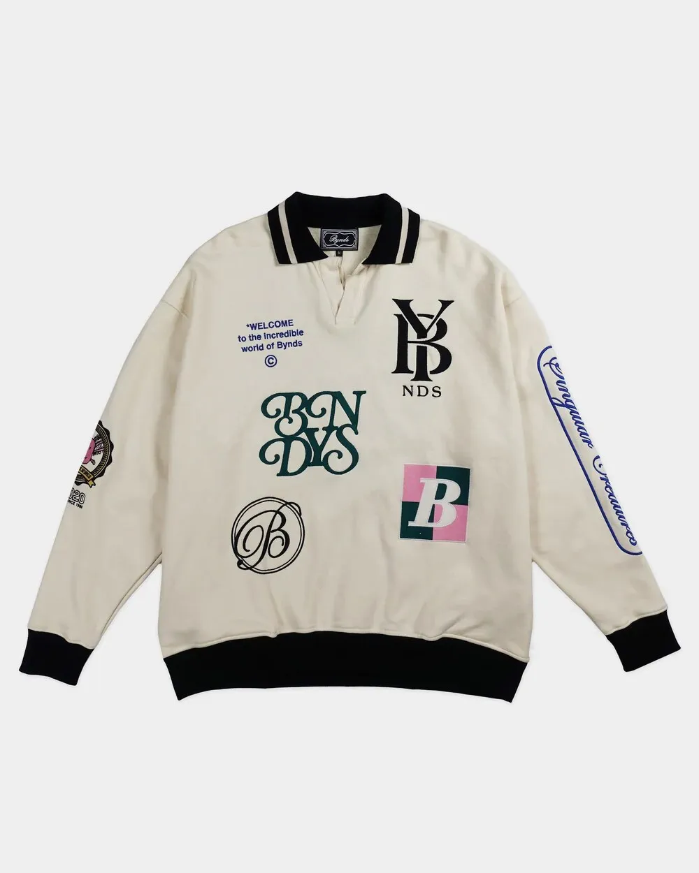 Cream BYNDS polo sweatshirt with black collar and embroidered badges