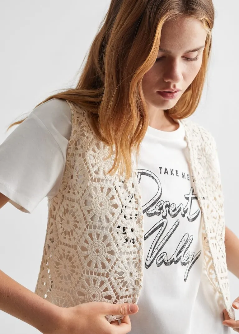 White T-shirt with “Take me to Desert Valley” script print under a crochet vest, for Mango